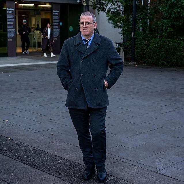 Stephen Eppingstall in a grey coat walking outside the Morwell courthouse