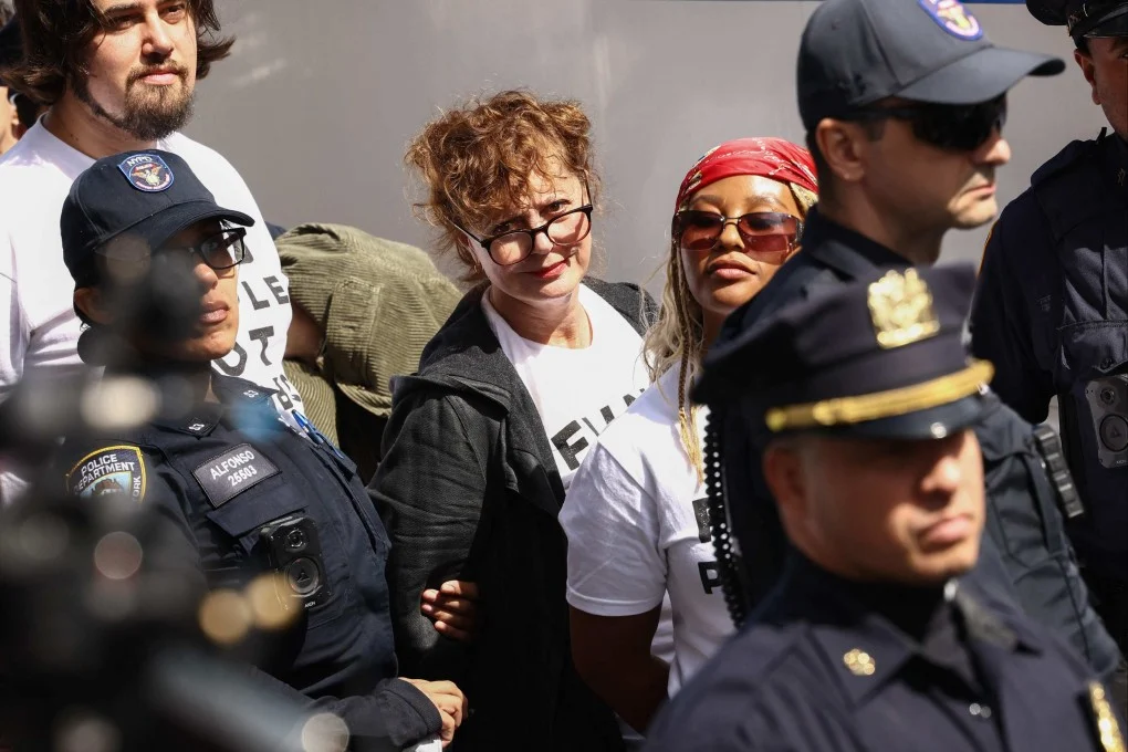 เจ้าหน้าที่ตำรวจนครนิวยอร์ก (NYPD) ควบคุมตัวนักแสดงชาวอเมริกัน ซูซาน ซาแรนดอน (กลาง) และผู้ประท้วงสนับสนุนปาเลสไตน์ที่ปิดกั้นถนนเฟิร์สต์อเวนิวใกล้กับอาคารสำนักงานใหญ่สหประชาชาติ ก่อนที่นายกรัฐมนตรีอิสราเอล เบนจามิน เนทันยาฮู จะกล่าวสุนทรพจน์ต่อสหประชาชาติในวันพฤหัสบดี ภาพ: AFP