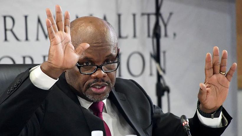 Shadrack Sibiya is seen with his hands up as he testifies at a public inquiry investigating police corruption