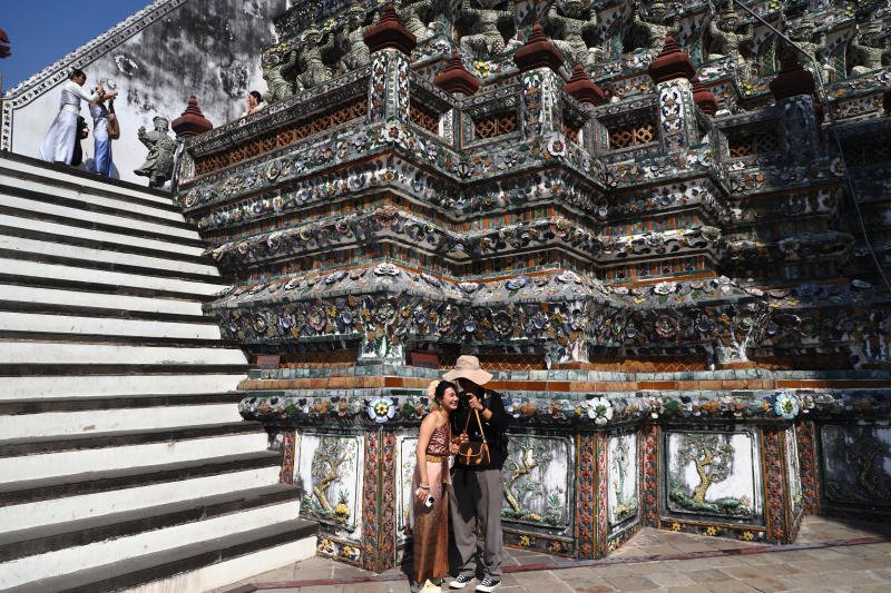 นักท่องเที่ยว สวมชุดไทย ถ่ายภาพที่วัดอรุณฯ เมื่อ 7 มกราคม 2568 (ภาพ: Nutthawat Wichieanbut)